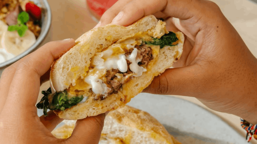 breakfast muffin with hands in frame