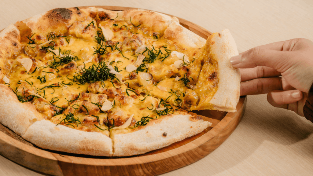 new pork pizza by Flock with hands in frame