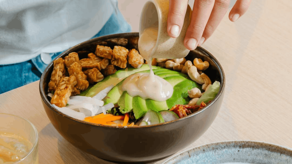 our tempeh salad bowl with sauce is plant based bali food