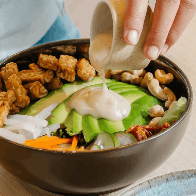 our tempeh salad bowl with sauce is plant based bali food